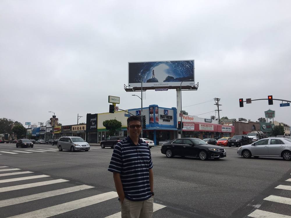 Douglas Sandquist beneath the billboard in Los Angeles